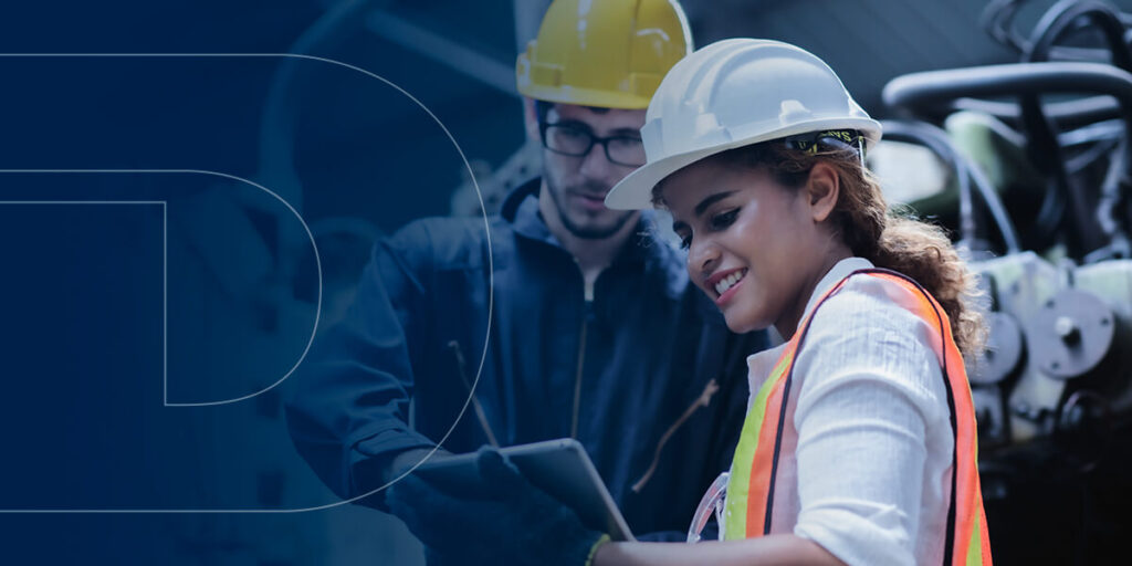 Man and woman in construction gear looking at a clipboard